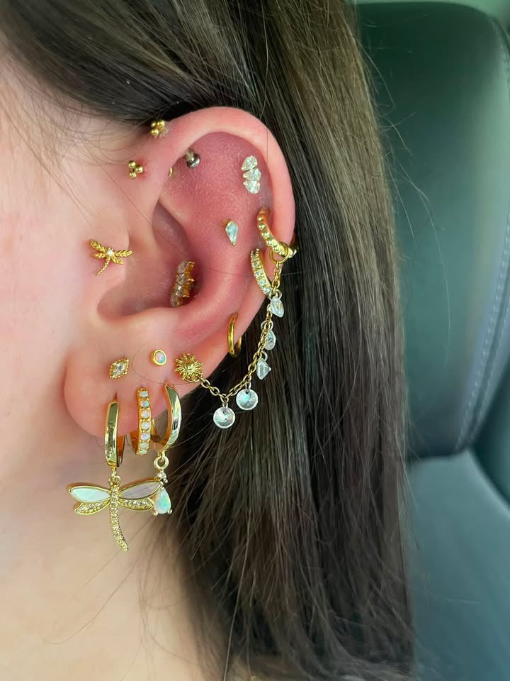 Audree Proffitt ear stack featuring gold and crystal jewelry
