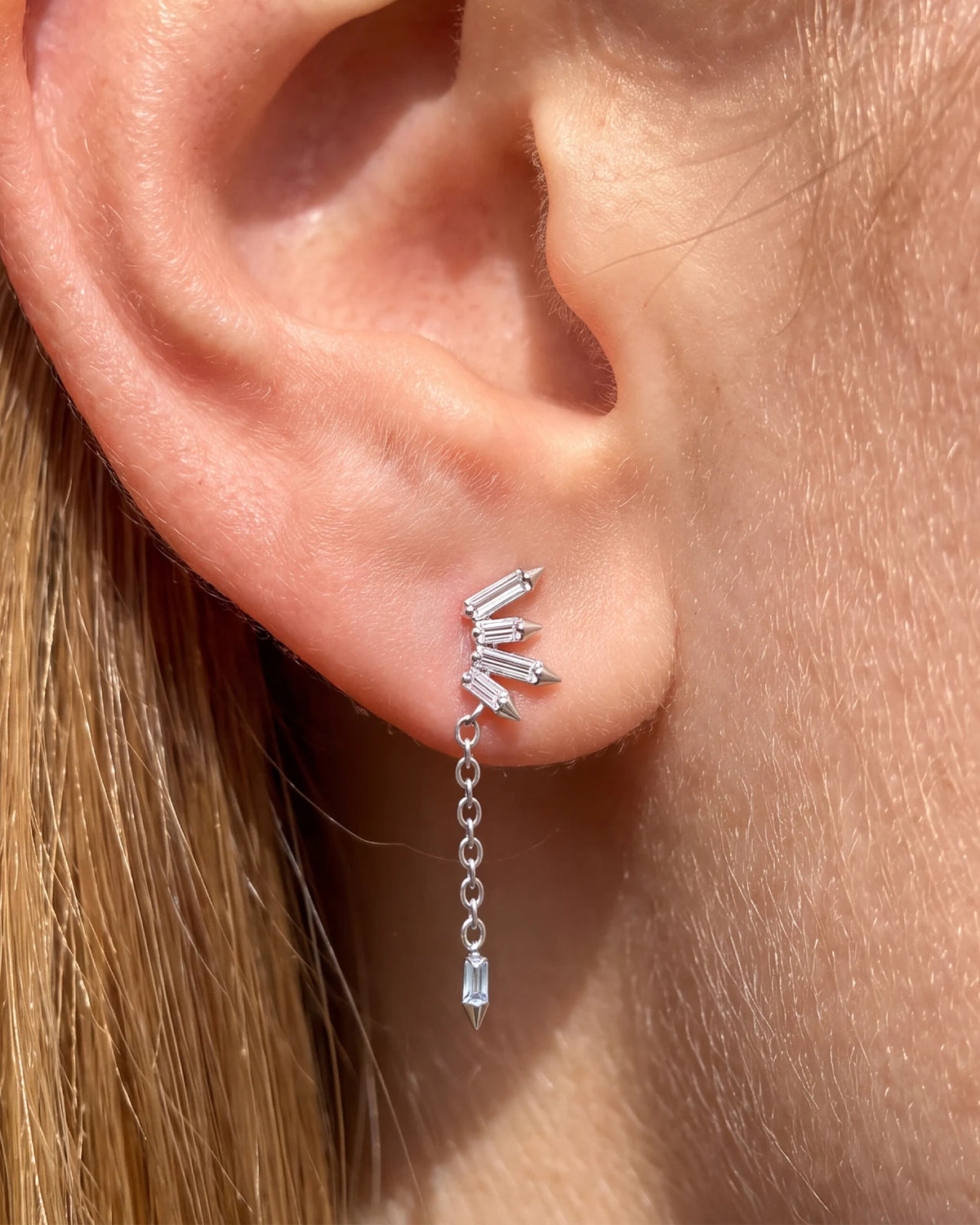 Prism Drift Flatback Stud, silver with clear stones and a pale blue chain charm, on-ear styling