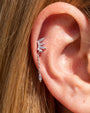 Prism Drift Flatback Stud, silver with clear stones and a pale blue chain charm, on-ear styling