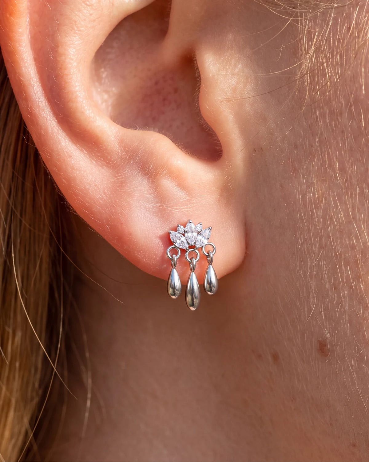 Petal Rain silver clear stone flatback stud styled on the earlobe