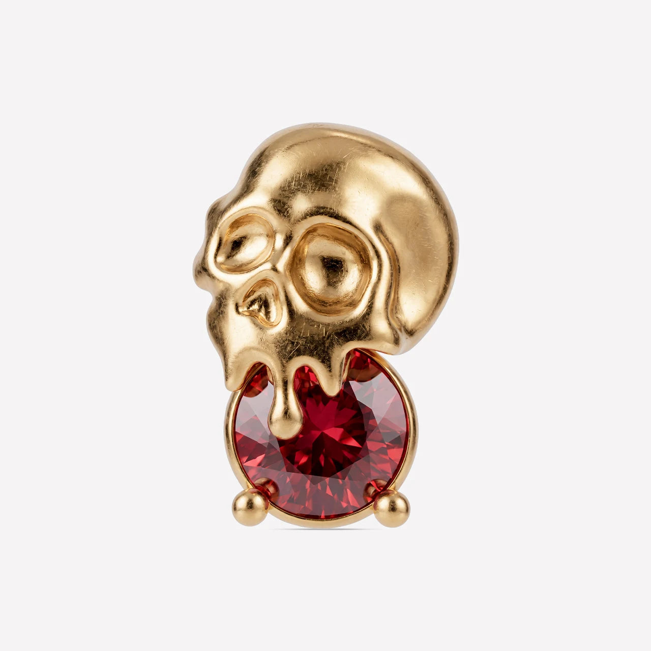 Skull Melt Flatback Stud in gold tone with garnet red cubic zirconia - front view