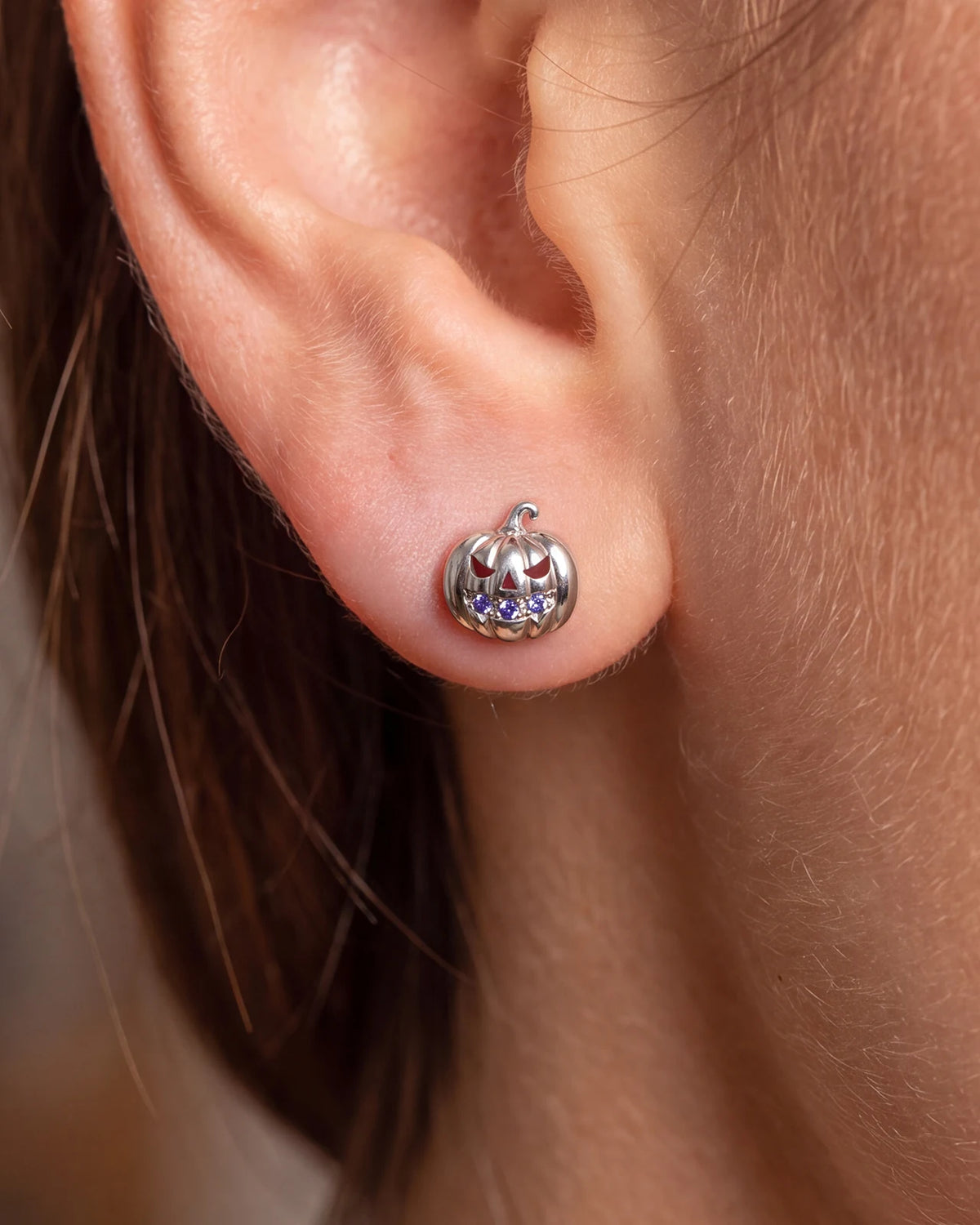 Wicked Grin pumpkin flatback stud, silver with purple blue cubic zirconia, lobe styling