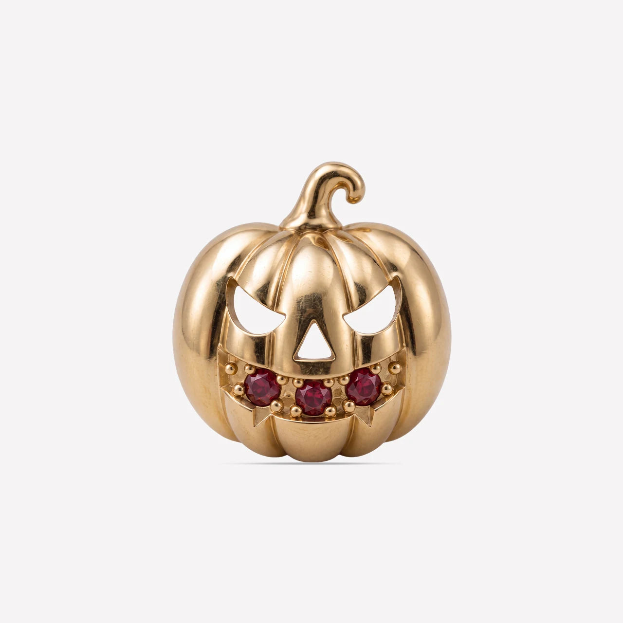 Wicked Grin pumpkin flatback stud, gold with red cubic zirconia, front view