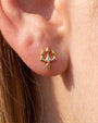Gold trident flatback stud styled in a curated ear