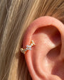 Gold Lucky Bloom Huggie Clicker worn on lobe