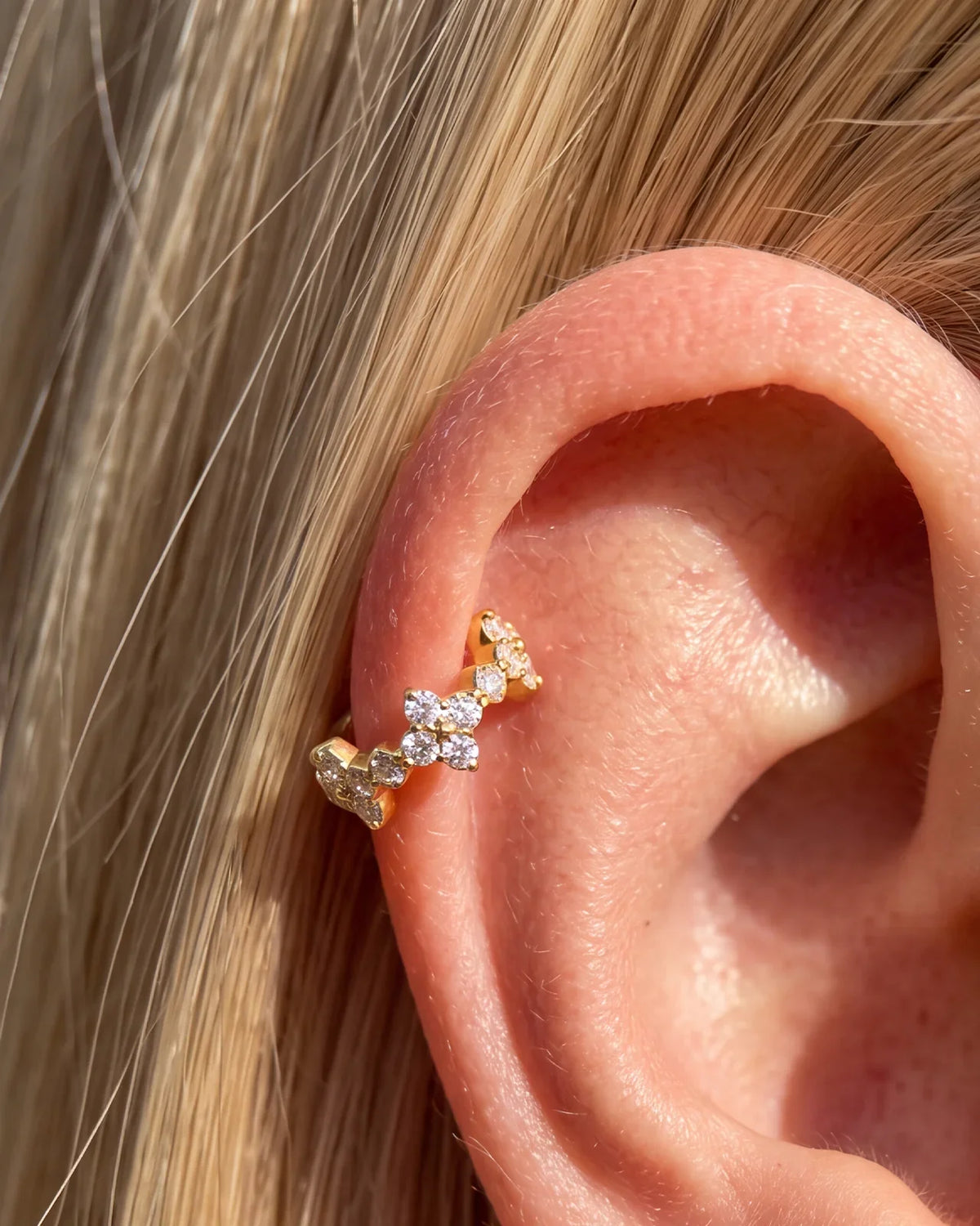 Gold Lucky Bloom Huggie Clicker worn on lobe