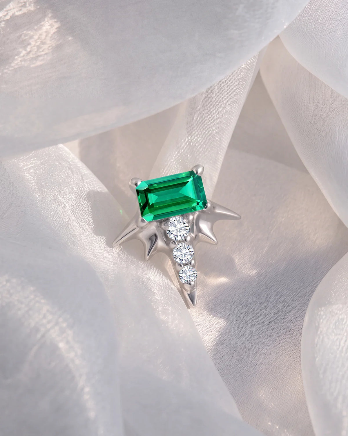 Radiant Wingcrest Flatback Stud, silver tone with green center stone, styled product view
