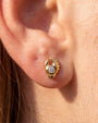 Tidal Claw gold crystal clear flatback stud worn in lobe piercing