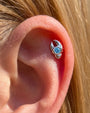 Tidal Claw silver ocean mist flatback stud worn in helix piercing